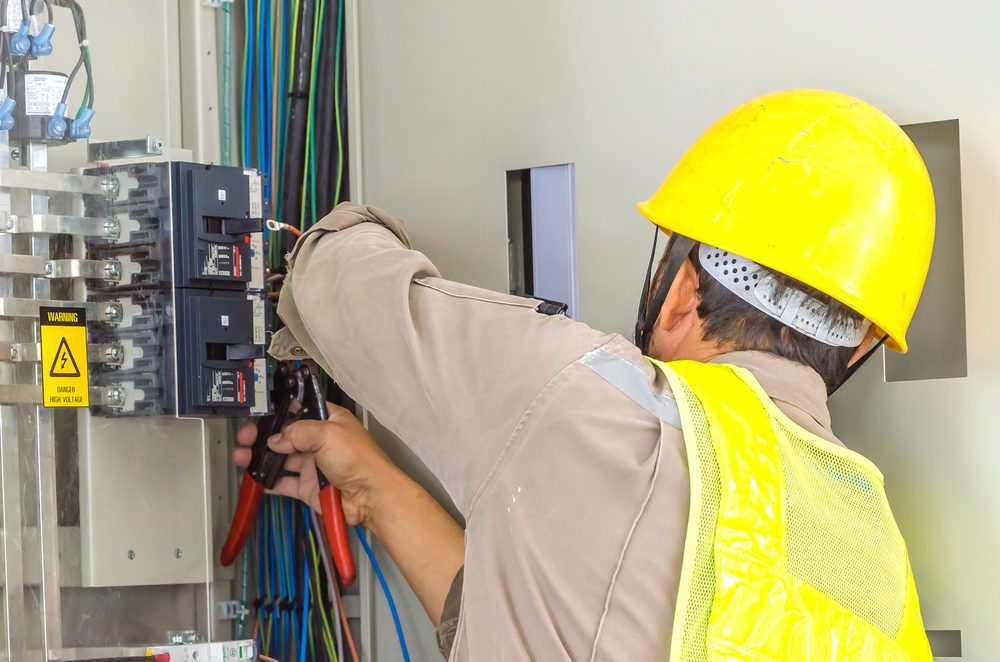 Professional electrician checking electrical lines